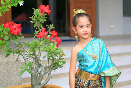 Beautiful asian little child girl wearing traditional thai style dress.の写真素材