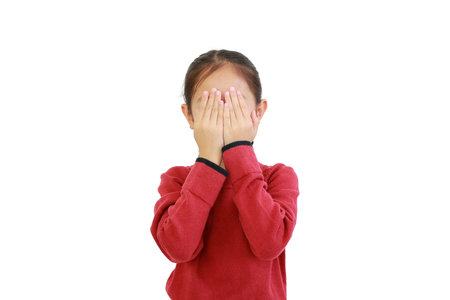 Portrait of little asian girl covering eyes with hands isolated on white background with clipping path.の写真素材