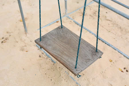Wooden swing in the garden.