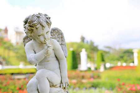 Cupid sculpture in summer garden outdoor.の写真素材