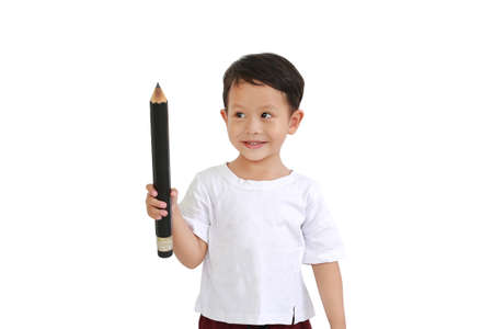 Asian little boy holding big pencil and looking up isolated on white background. Kid and education conceptの写真素材