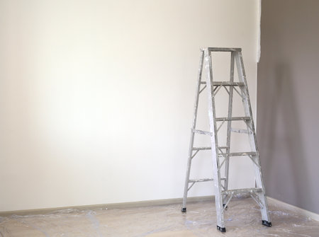 Aluminium ladder in empty room of new house for technician use to higher jobs. Image with copy spaceの写真素材