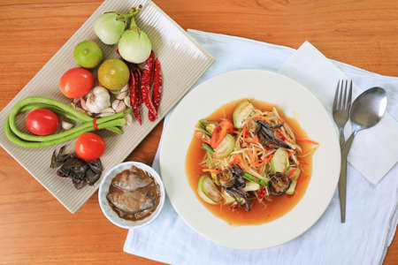 Papaya Salad (Som Tam) the traditional Thai foods on wood table background. Most wanted popular food in Thailandの写真素材