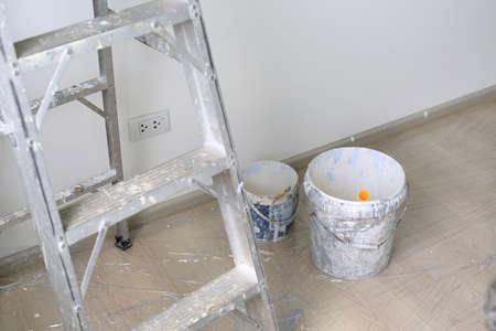 Aluminium ladder and paint bucket in empty room of new house.の写真素材