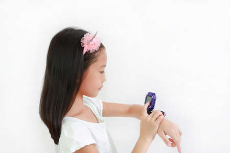 Portrait of Asian little girl using smart watch video camera against white backgroundの写真素材