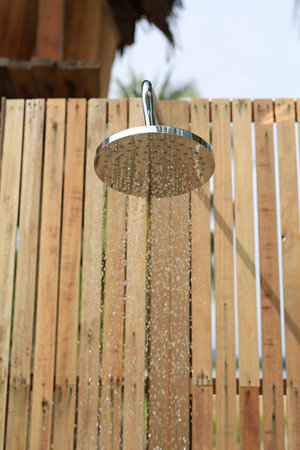 Outdoors shower while running water in the garden.の写真素材