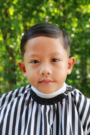 Asian boy cut in haircut in the garden, fashion haircut for a guy.の写真素材