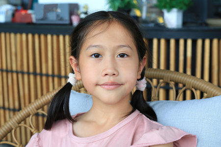 Portrait of Asian young girl child age about 9 years old looking camera, Close up.の写真素材