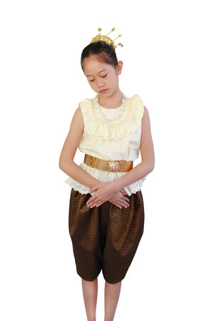 Asian girl child in traditional Thai costume dress with Showing a sad or regret expression isolated on white background. Image with clipping path.の写真素材