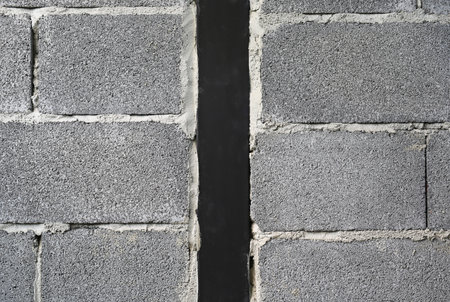 New concrete brick block wall texture background with black metal at center.