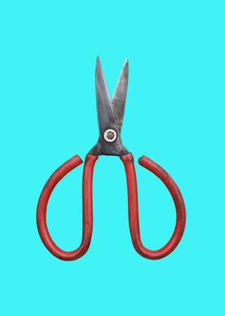 An old iron scissors for industrial use isolated on cyan background. Image with clipping path.の写真素材