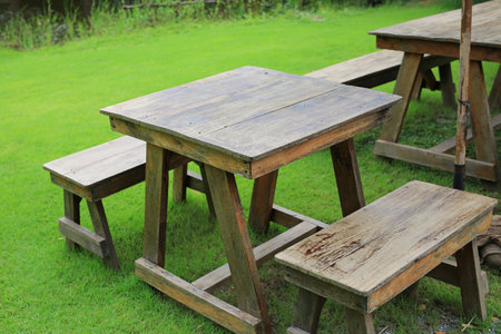 Wooden table and benches in the garden. Garden furniture for outdoor recreation.