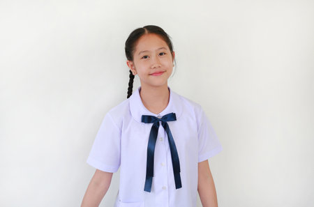 Portrait of happy pretty Asian student girl in school uniform against white studio background.の写真素材