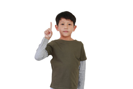 Portrait of Asian boy child showing one index finger with looking camera isolated on white background.の写真素材