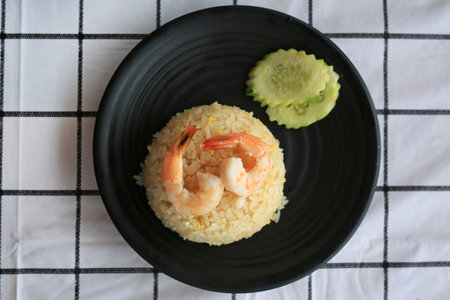 Shrimp fried rice with vegetable in black plate on the table, Asian food. Top view.の写真素材