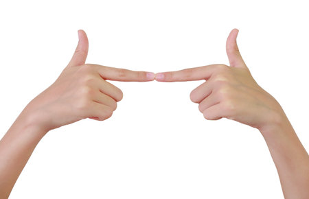 Left and right hands reaching towards each other with index fingers against white background.の写真素材