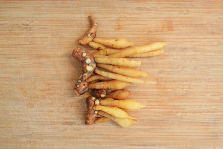 Finger root or Chinese ginger on bamboo wooden background, preparation process for cooking. Top view.の写真素材