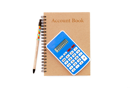 pencil and calculator lying on opened account bookの写真素材