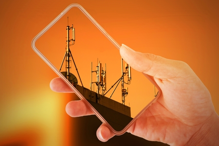 Double exposure. Hand holding smartphone Overlapping image telephone tower.の写真素材