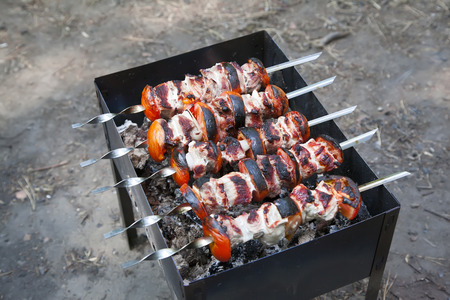 Marinated shashlik, meat grilling on metal skewer, close upの写真素材