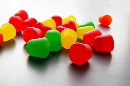 Assorted brightly colored candy gum drops and boxの写真素材