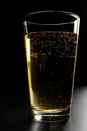 Pint of bubbly beer on dark backgroundの写真素材