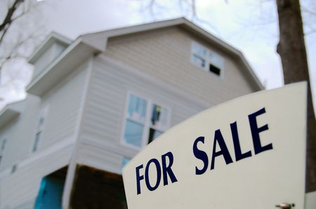 House for sale with closeup of sign in frontの写真素材