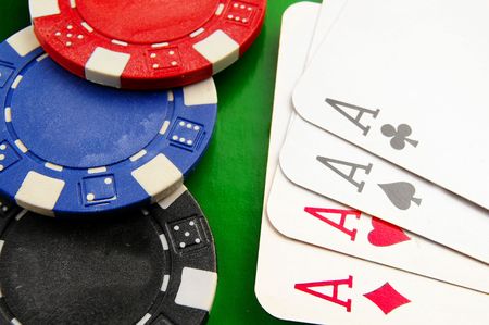 Stacked poker chips and cards on tableの写真素材