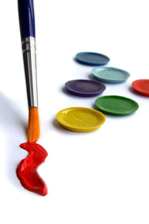 Paint brush, red paint,  and paint pallet closeupの写真素材