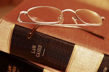Closeup of eye glasses on top of legal booksの写真素材