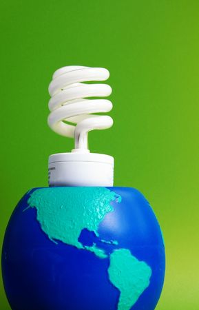 light bulb and an earth globe, on green backgroundの写真素材