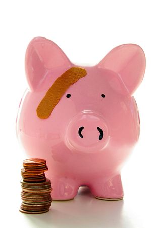 Piggy bank with band-aid. Symbolizes health-care costsの写真素材