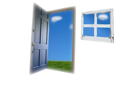 Door opening to green grass and blue skyの写真素材
