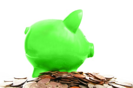 piggy bank and assorted coins, on whiteの写真素材