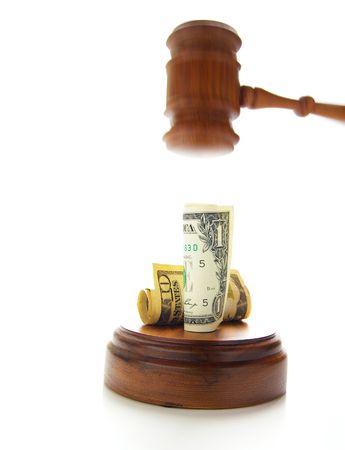 judges gavel about to pound on moneyの写真素材