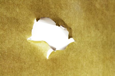hole torn in a piece of material, with white centerの写真素材