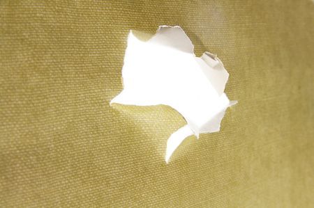 hole torn in a piece of material, side viewの写真素材