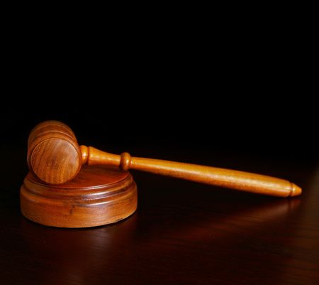 court gavel on desk, over dark backgroundの写真素材