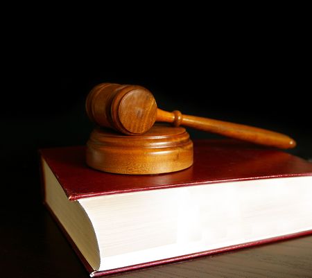 judges court gavel sitting on a law bookの写真素材
