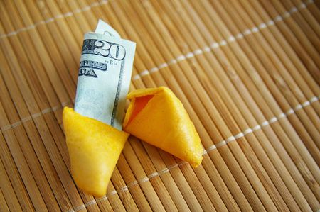 broken open fortune cookie, with money insideの写真素材