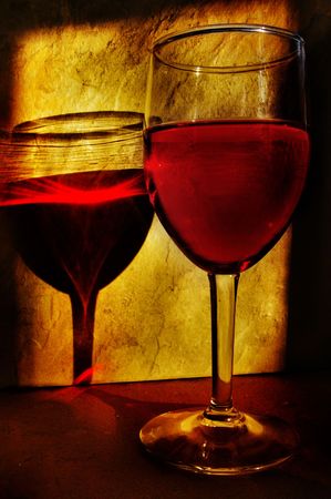 single wine glass and reflection in warm evening sunlightの写真素材