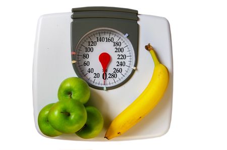 apples and banana on a scale (healthy diet)の写真素材