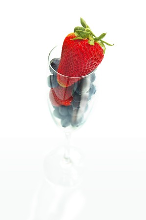 strawberry and blueberries in a champagne glassの写真素材