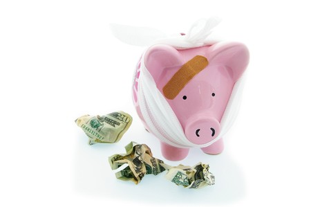 bandaged piggy bank with cashの写真素材