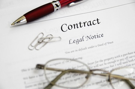 legal contract papers with pen and glassesの写真素材