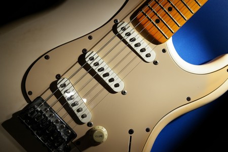 closeup of an electric guitar, on blueの写真素材