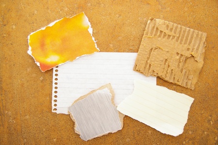 assorted pieces of ripped scrap paper, on grunge backgroundの写真素材