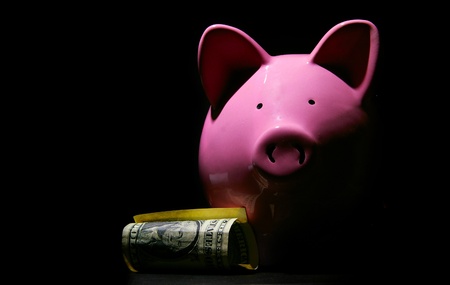 piggy bank and U.S. dollar, on blackの写真素材