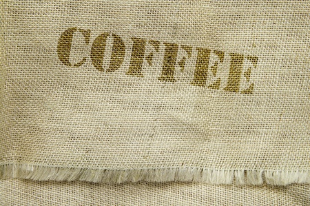 coffee text on a burlap textured fabricの写真素材