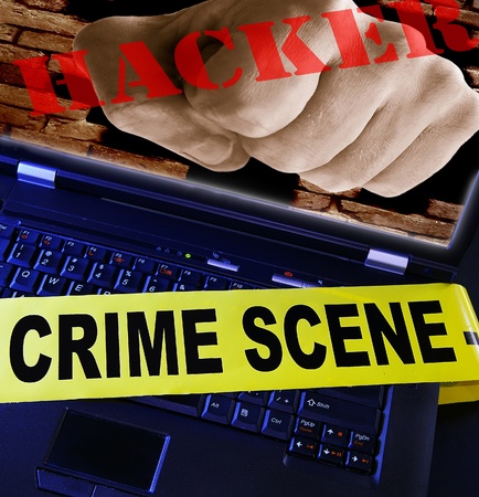 laptop  with yellow crime scene tape across and hacker fistの写真素材